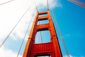 Poster - Close up of single tower of Golden Gate Bridge in white clouds San Francisco, USA, bottom view