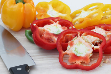 Poster - peppers on the kitchen cutting board in a white background.