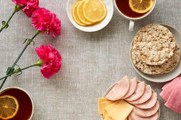 Wall Mural - Breakfast with ham and cheese on a gray fabric background