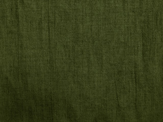 Green cloth background. Rough cotton fabric texture. Dark green natural old shabby fabric background. Khaki grunge backdrop for your design.