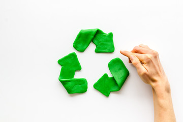 Wall Mural - Recycling symbol - composition with hands - on white background top-down copy space