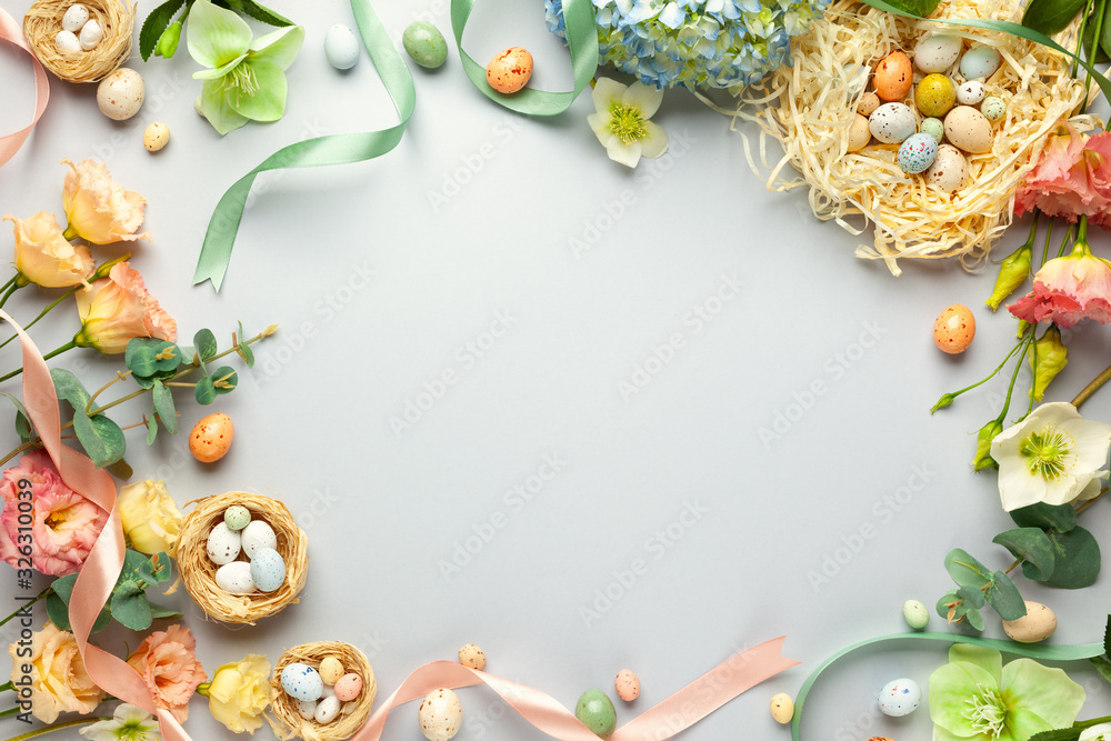 Happy Easter concept with easter eggs in nest and spring flowers ...