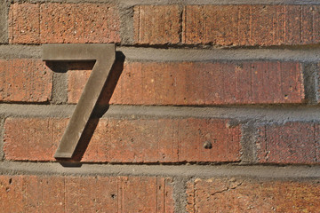 Number seven on a brick wall with copy space