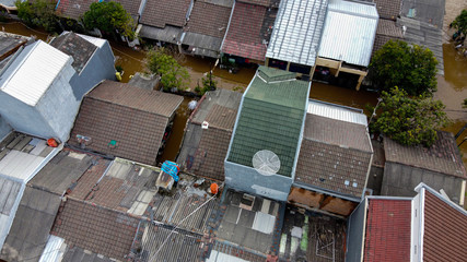 Wall Mural - Aerial POV view Depiction of flooding. devastation wrought after massive natural disasters at Bekasi - Indonesia