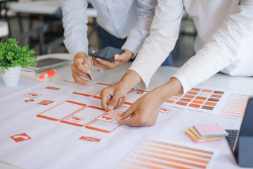 Wall Mural - cropped shot of creative ux ui designers team designing, developing mobile application from prototyp
