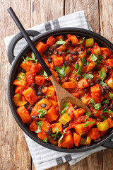 Wall Mural - fried sweet potato black bean chili close-up in a pan. Vertical top view