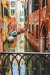 Venice, Italy. Narrow channel street and colored houses with local boats in Venezia