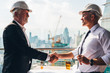 © Shutter B - Two engineer wear safety helmet shaking hands after meeting for architectural project working with partner. Worker and customer having agreement in factory. Industry, Engineering, construction concept