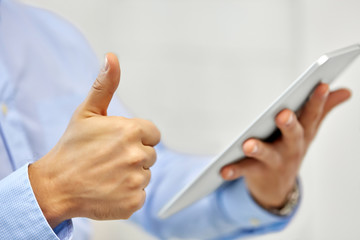 Wall Mural - business, people and technology concept - close up of male hands with tablet pc computer showing thumbs up