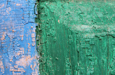 Old wooden background with remains of pieces of scraps of old paint on wood. Texture of an old tree, vintage wood background peeling paint. old blue board with cracked paint