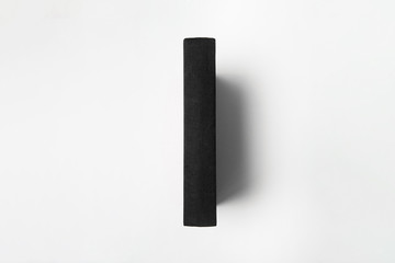 Vertically standing blank black Book Mock up on a white background.High resolution photo.