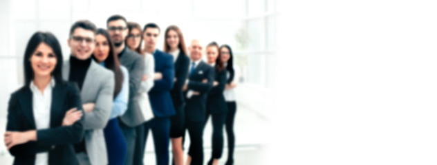 happy group of diverse young people standing in a row. background in blur