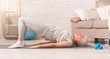 © Prostock-studio - Active senior woman doing back exercise on floor at home
