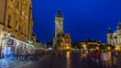 Prague Old Town Hall at Night timelapse with unrecognizable tourists walking