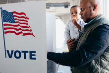 Father And Son Voting On Election Day