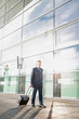 © moodboard - Businessman walking with his suitcase in the airport