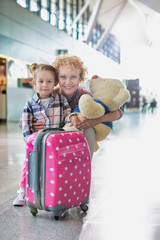 Wall Mural - Portrait of mother reuniting with her daughter in airport with lens flare