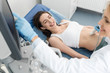 © LIGHTFIELD STUDIOS - doctor examining belly of happy pregnant woman with ultrasound scan in clinic