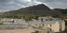 Unsightly Mining Spoil Tips Towering Above Houses And Roof Tops In The Welsh Town Of Blaenau Ffestiniog UK