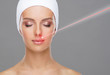 © Acronym - Doctor removing birthmarks with a laser ray. Beautiful face of a young woman. Mole removal, plastic surgery, skin lifting and aesthetic medicine.