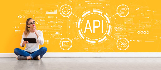 API - application programming interface concept with young woman holding a tablet computer