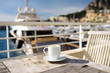 Cup of coffee on a wooden table on balcony hotel in Principality of Monaco.