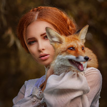Close Up Portrait Amazing Cute Young Woman In Beautiful Fairy-tale Image With Fire Red Hair In White Lace Dress Looks In Camera And Holds Small Red And White Fox In Yellow Autumn Pictorial Forest