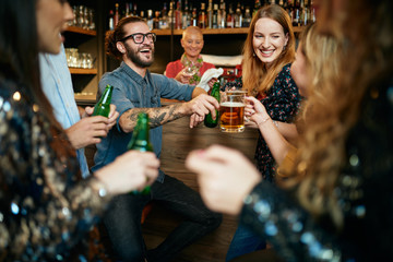 Poster - Group of friends drinking beer, chatting and having good time at pub. Night out.