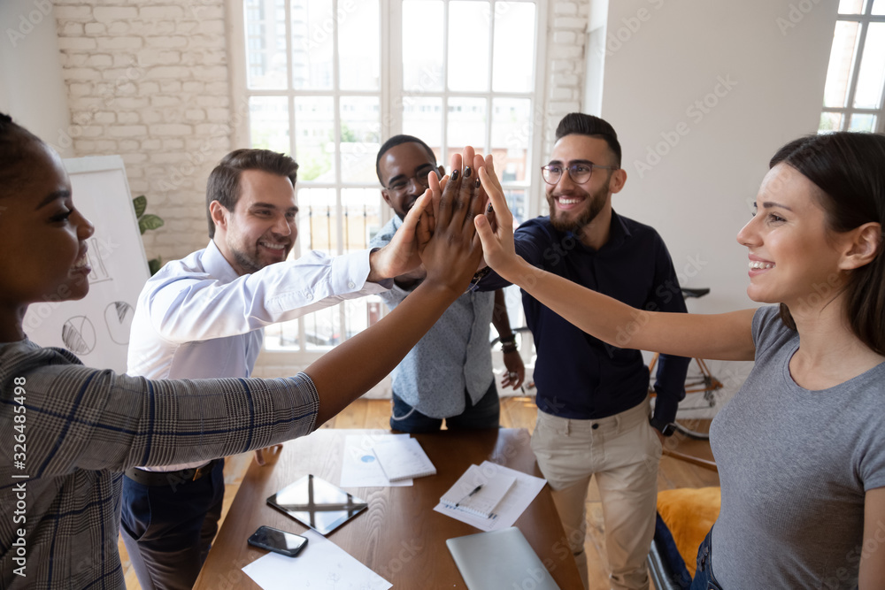 Happy businesspeople celebrating success at common business giving high ...