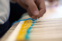 Little Children Hands Weaving Loom In Art Theraphy Class At School. Education Concept. Telar Weave Looom.