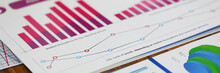 Close-up Of Biz Documents With Statistics Data In Charts, Graphs And Diagrams. Financial Forecast Of Growth Income. Stock Exchange, Securities Market Concept. Blurred Background