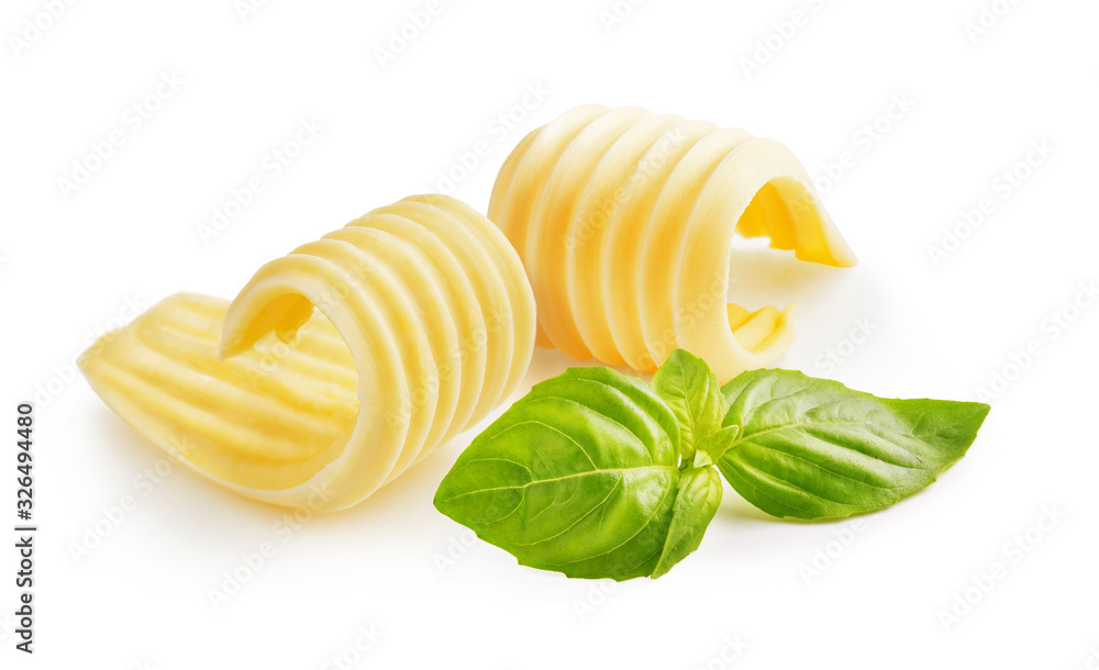 Butter curls or butter rolls with basil leaves isolated on white background - obrazy, fototapety, plakaty 