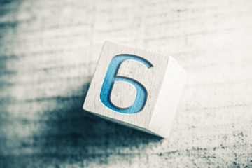 Poster - Number 6 On A Wooden Block On A Table