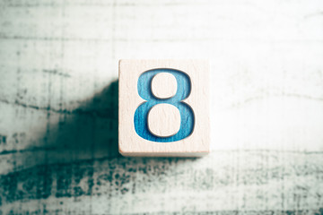 Poster - Number 8 On A Wooden Block On A Table