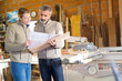 © auremar - carpentry manager and foreman studying a blueprint