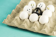 Black egg among angry, prejudiced white eggs attacking the black one. Xenophobic, racist concept.