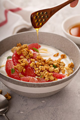 Wall Mural - Yougurt bowl with grapefruit slices, honey and granola