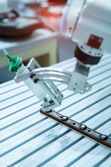 Poster - Robot holding glue syringe Injection in factory