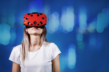 Young woman plays with virtual reality glasses