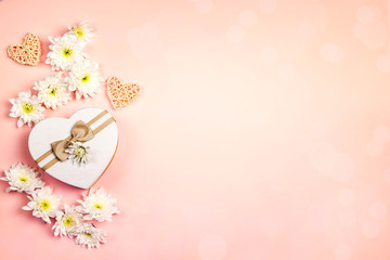 Poster - Heart shaped gift box with chrysanthemums and hearts on a pink background.