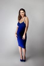 Catalog Style Studio Shot Of A Caucasian Female Fashion Model Wearing A Navy Or Royal Blue Summer Dress.  She Is Posing To Show Trendy Style Of The Outfit Or Clothing