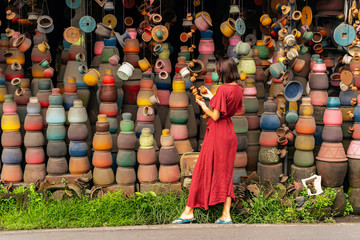 Relaxed young female person choosing souvenirs to buy