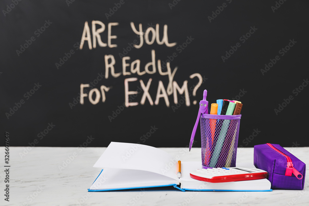 Stationery on table in classroom. Concept of preparation for exam