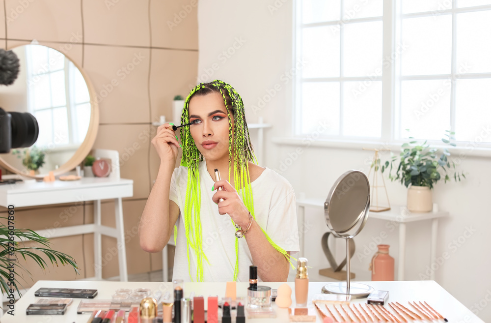 Transgender woman applying makeup at home