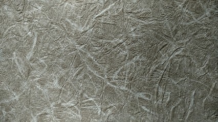 a photo of the pattern and texture of the gray wallpaper that adorns the walls