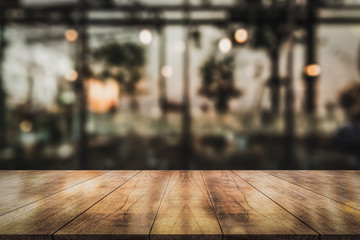 Empty wooden table top with lights bokeh on blur restaurant background