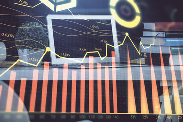 Forex market chart hologram and personal computer background. Double exposure. Concept of investment.