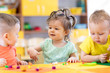 © Oksana Kuzmina - Small kids play on lesson in kindergarten