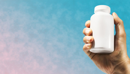 Fototapete - Hand hold white bottle for pills on a collage concept, contemporary colors and mood social background.