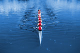 Boat coxed eight Rowers rowing on the blue lake. Classic Blue Pantone 2020 year color.
